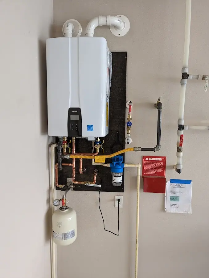 Professional plumber installing copper piping in a Oak Grove home